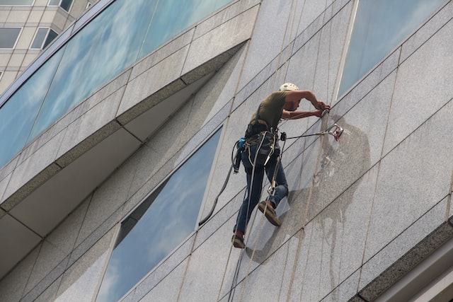 person washing buildings exterior