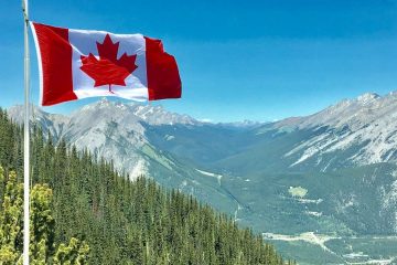 flag of canada on a background of mountains