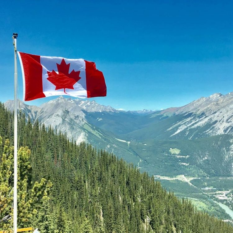 flag of canada on a background of mountains
